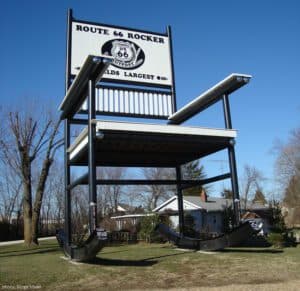 A giant rocking chair structure with a sign that reads "Route 66 Rocker - World's Largest."