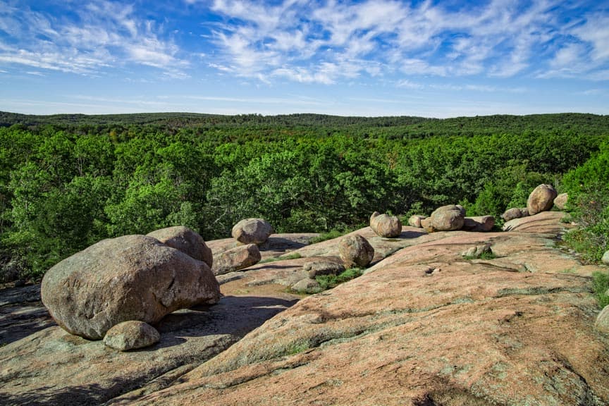 rock cliff overlooking a forest rock cliff overlooking a forest
